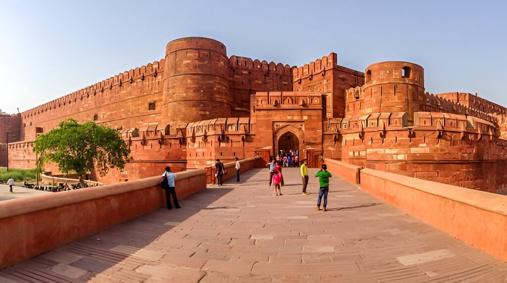 Agra Fort – Historic Red Sandstone Fort in Agra Agra Fort entrance with massive red sandstone walls and tourists exploring the historic Mughal monument